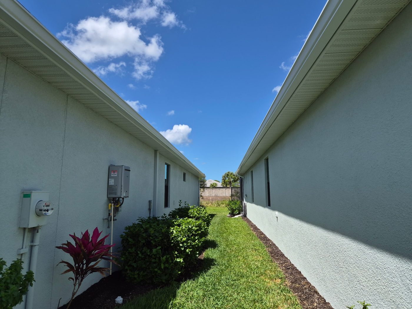 Home exterior with gutters and soffits between two houses in Sarasota FL