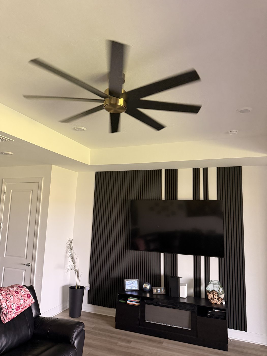 Modern black and brass ceiling fan installation in Sarasota FL home