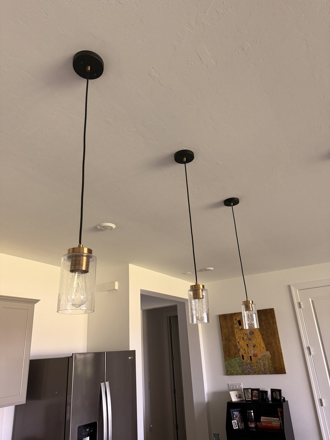 Three pendant lights installed over kitchen island in Sarasota FL