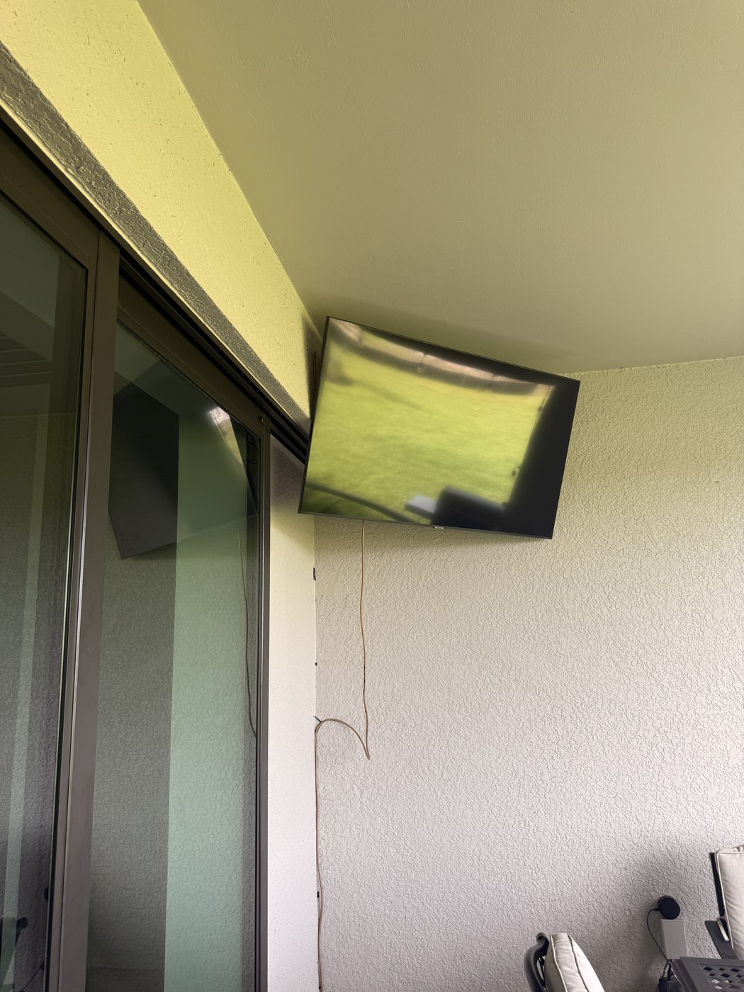Outdoor TV mounted on lanai wall in Sarasota FL