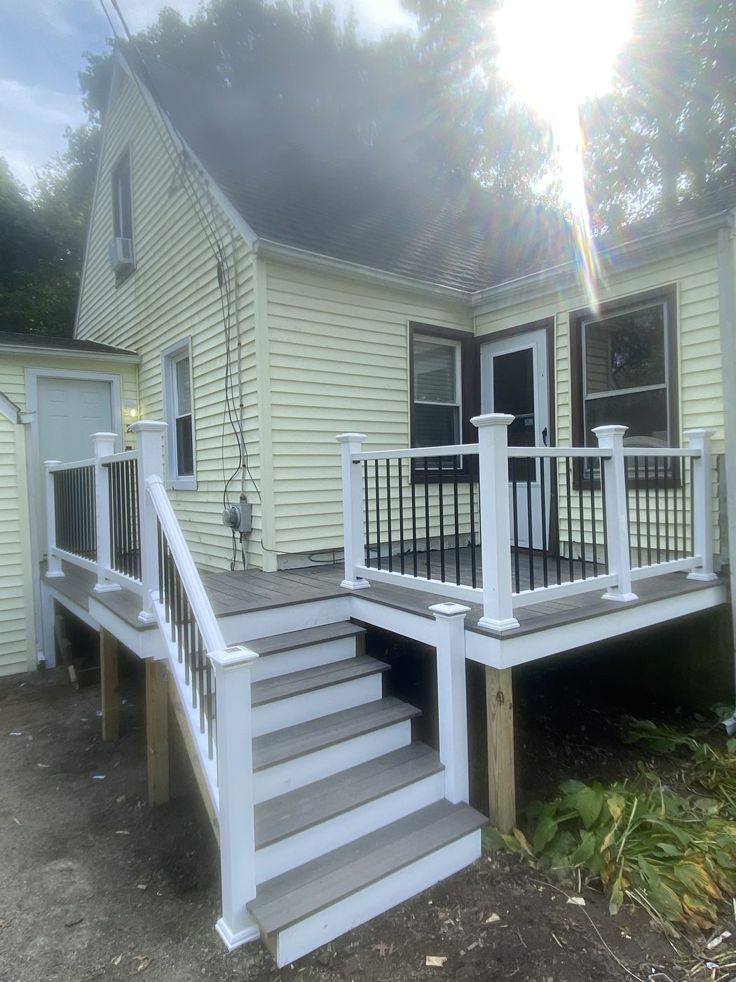Finished composite deck build with white vinyl railings