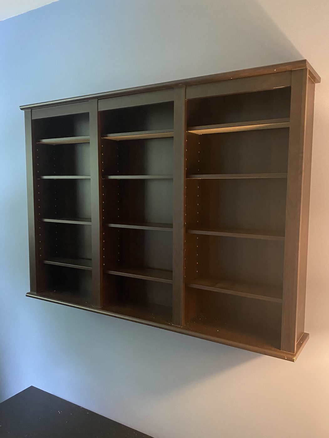 Custom built-in wall shelving unit installation