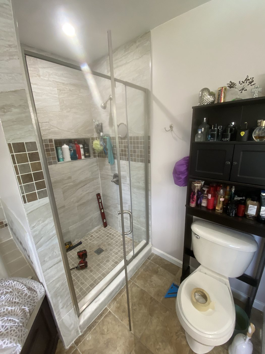 Custom tiled walk-in shower installation with glass door