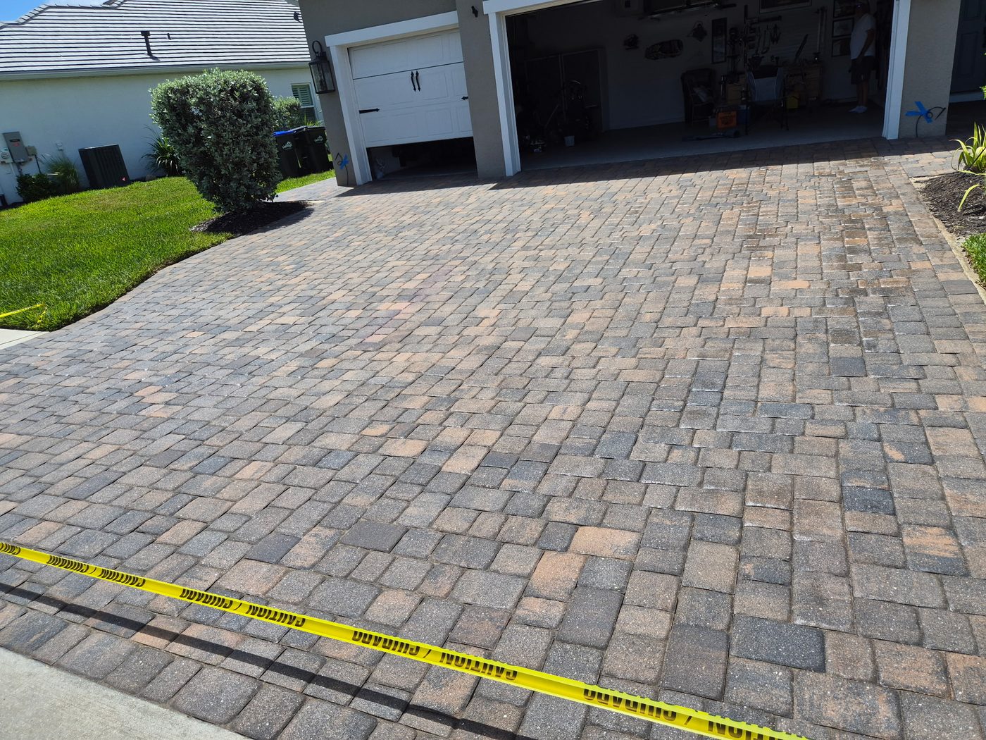 Driveway pavers before sealing, dull and stained