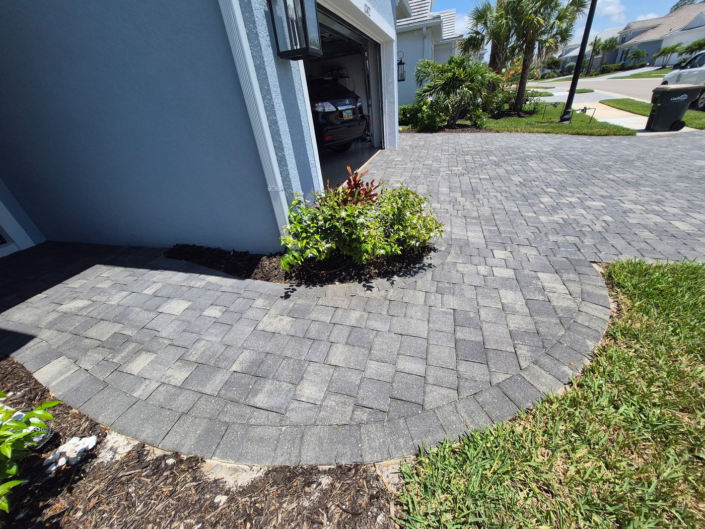 Curved sealed paver walkway alongside garage in Wellen Park FL